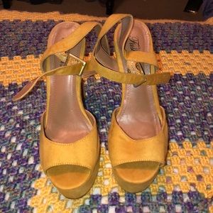 Mustard suede platform shoe.